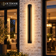 LumaLine Stainless wall light installed beside a brick entry